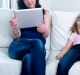internet network addict mother using digital tablet pad ignoring little sad daughter left alone bored and depressed ...