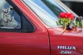 A floral tribute is laid on a 4WD out the front of the home.