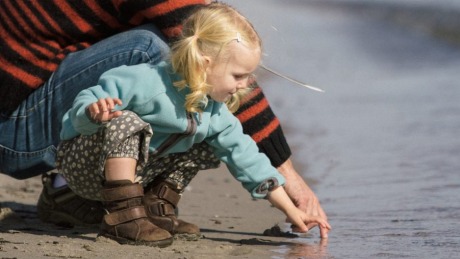 2.5 year old toddler enjoying the late summer at the beach with her dad. generic outdoors nature father young daughter ...