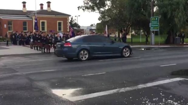 An image of the sedan passing the Anzac Day marchers in Elmore.