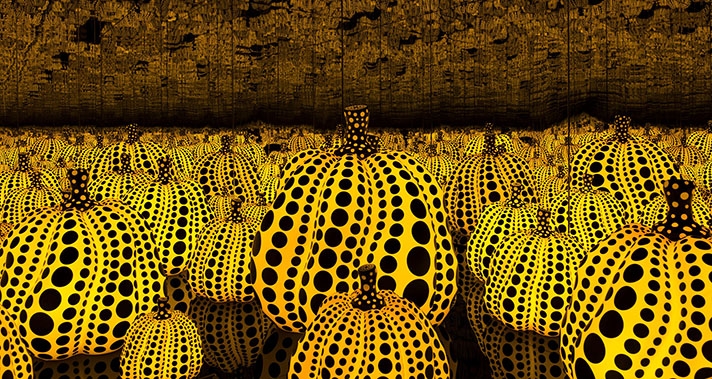 cropped image of yellow and black pumpkins in mirror room