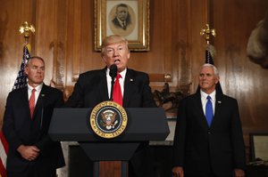 President Donald Trump, flanked by Interior Secretary Ryan Zinke, left, and Vice President Mike Pence, speaks at the Interior Department in Washington, Wednesday, April 26, 2017, before signing an Antiquities Executive Order.