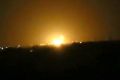 Flames rise after an explosion near an airport west of Damascus, Syria.