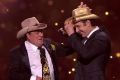 Molly Meldrum gifts Samuel Johnson with a golden Stetson.