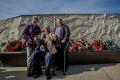 Pieta Laut (R) paid respects to her fallen  brother Bryce Laut, with her mother Jan Laut (L) and father Peter Laut (centre).