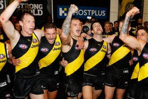 Yellow and black: Richmond players belt out the song on Anzac Eve.