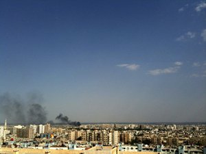 In this Thursday, July 19, 2012 file photo, smoke rises over the skyline in the Qaboun neighborhood of Damascus, Syria, during shelling by Syrian government forces.