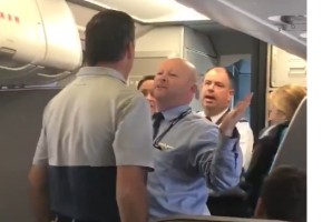 The American Airlines flight attendant can be seen getting into a verbal argument with another passenger.