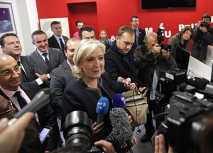 File - Far-right leader Marine le Pen answers reporters as she inaugurates her campaign headquarters, Wednesday, Nov.16, 2016 in Paris.