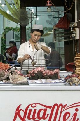 A Muslim street vendor selling snacks on Beiyuanmen street in Xian, China.