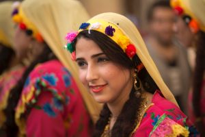 A dancer smiles as she wears traditional costumes for the women of Nile Delta province of Sharqiya, as she participates ...