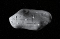 A computer-generated rendering of several small robotic spacecraft mining a potential near-Earth asteroid.