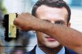 A supporter of French centrist presidential candidate Emmanuel Macron glues a campaign poster in Bayonne, south-western ...