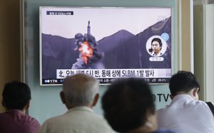 People watch a TV news program showing a file footage of North Korea's ballistic missile that the North claimed to have launched from underwater, at Seoul Railway station in Seoul, South Korea, Wednesday, Aug. 24, 2016.