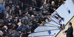 French President Francois Hollande speaks with the media as he arrives for an EU summit in Brussels on Saturday, April 29, 2017.