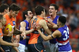 The Giants' Jeremy Cameron clashes with Tom Boyd of the Bulldogs during the first preliminary final last September.