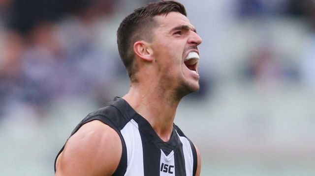 Collingwood captain Scott Pendlebury roars in celebration after kicking a goal against Geelong at the MCG on Sunday. 