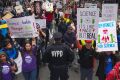 Demonstrators pass a policeman in the March for Science in New York last week.