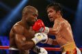 Legend: Manny Pacquiao lands a blow in his loss to Floyd Mayweather.