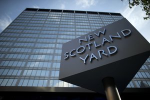 A sign rotates outside New Scotland Yard, the headquarters building of London's Metropolitan Police force in central London, Tuesday, Oct. 30, 2012.