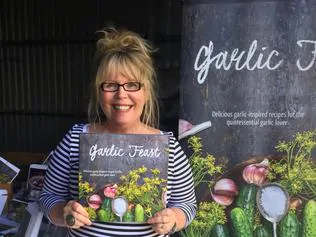 Cookbook author Janice Sutton with her new cookbook Garlic Feast. For The Grill by Penny McLeod tasweekend 21 May