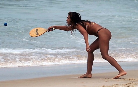 A woman plays frescoball at Ipanema beach in Rio de Janeiro.