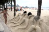 A girl looks at a sand sculpture at Copacabana beach in Rio de Janeiro.