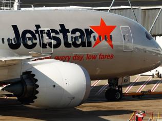 An aircraft of Jetstar Airways, the budget arm of Qantas Airways Ltd., stands at Sydney Airport in Sydney, Australia, on Monday, June 22, 2015. Australia's central bank reiterated the need for deeper currency declines to balance economic growth that's predicted to remain below average until the latter part of 2016. "A lower exchange rate would have an immediate beneficial effect on some sectors such as tourism," the Reserve Bank said in minutes of its June policy meeting. Photographer: Brendon Thorne/Bloomberg