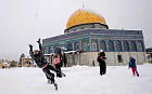 A heavy winter storm descended on parts of the Middle East on Friday, with snow forcing the closure of all roads leading in and out of Jerusalem and sprinkling Israel's desert with a rare layer of white. 