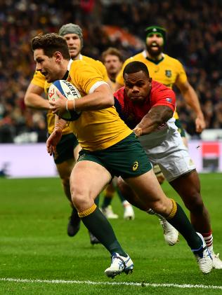 Bernard Foley darts over to score his side's second try during the international match between France and Australia at Stade de France.