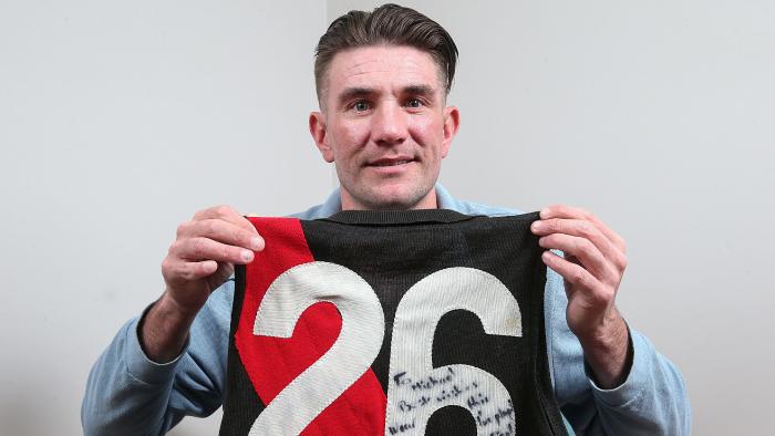 Mark Hardy with Mark "Bomber" Thompson's 1984 Essendon premiership jumper. Photo: Ian Currie