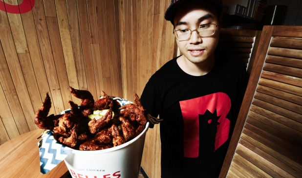 Belles Chicken. Restaurant supervisor Tim Huynh with a bucket of chicken. The chain says getting the right packaging is ...