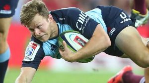 Cam Clark of the Waratahs is tackled during the round 10 Super Rugby match against the Reds.