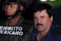 Mexican drug lord Joaquin "El Chapo" Guzman, right, is escorted to a waiting helicopter after his arrest. 