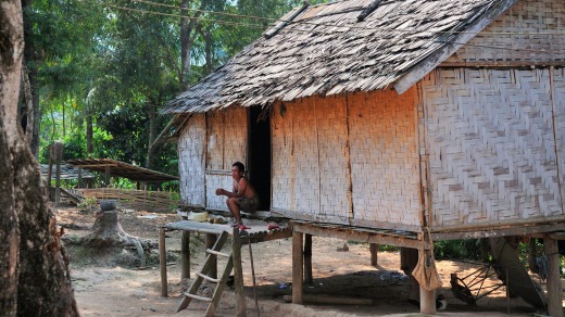 Traditional Hmong village house on stilts on the banks of The Mekong River, Northern Laos.