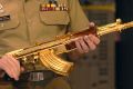 Major-General John Cantwell hands the gold-plated assault rifle to then War Memorial executive Nola Anderson in 2007.