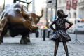 In this March 22, 2017 photo, the Charging Bull and Fearless Girl statues are shown on Lower Broadway in New York.