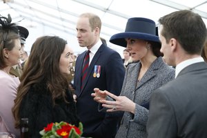 Britain's Prince William, centre, with Kate, Duchess of Cambridge, 2nd right, meet veterans and serving members of the British armed forces