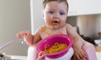 Baby eating pasta