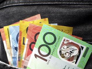 Budget2016 - stock images to be used for Budget 2016 stories. Australian money including 100, 50, 5, 10 and 20 dollar notes, in back pocket of a man's black charcoal jeans pocket. Vertical. Picture: istock