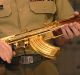 Major-General John Cantwell hands the gold-plated assault rifle to then War Memorial executive Nola Anderson in 2007.