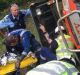 Emergency services help the woman as she remains trapped in the overturned RTV. Photo: NSW Police