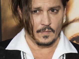 (FILES) This file photo taken on November 21, 2015 shows actor Johnny Depp at the Los Angeles Premiere of "The Danish Girl", in Westwood, California. Johnny Depp, facing abuse allegations from his estranged wife Amber Heard, has received prominent backing from his daughter and former partner Vanessa Paradis, with others also rushing to his defense. Heard, who filed for divorce in Los Angeles last week and appeared in court with a black eye, has accused the Oscar-nominated Hollywood star of assaulting her. / AFP PHOTO / VALERIE MACON