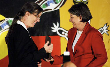 a woman being handed an award