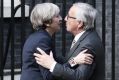 Theresa May greets Jean-Claude Juncker, president of the European Commission.