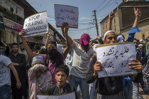 Kashmiri protester hold placards as they shout pro-freedom slogans during a protest in Srinagar, Indian controlled Kashmir