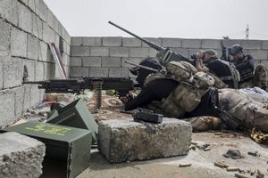 A soldier wit the Iraqi special aims at an Islamic State group position in west Mosul as fighting between Iraqi forces and the Islamic State group continues, Monday, April 24, 2017.