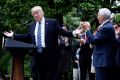 US President Donald Trump celebrates with Vice President Mike Pence and other Republicans after the House voted to pass ...