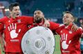 Bayern's Arturo Vidal carries a mock trophy as he and his teammates celebrate winning the title.