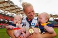 Hands full: Erin Phillips celebrates with twins Blake and Brooklyn after Adelaide's win in the AFLW grand final.